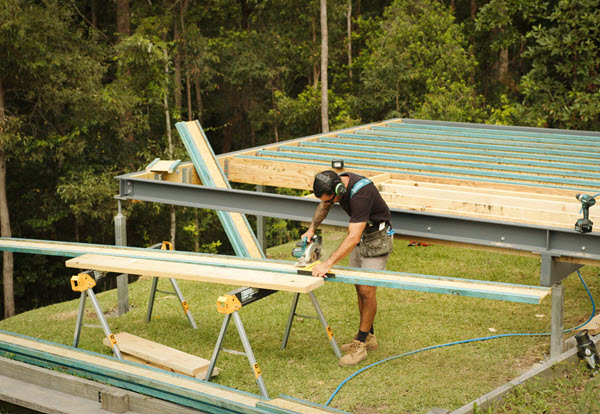 Builder Cutting Structural Timber For A House Project